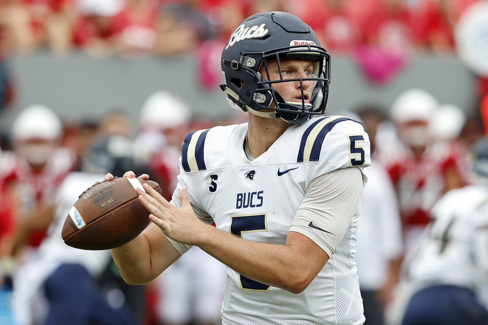 Charleston Southern's Ross Malmgren (5) looks to throw the ball against the North Carolina State during the first half of an NCAA college football game in Raleigh, N.C., Saturday, Sept. 10, 2022. (AP Photo/Karl B DeBlaker)