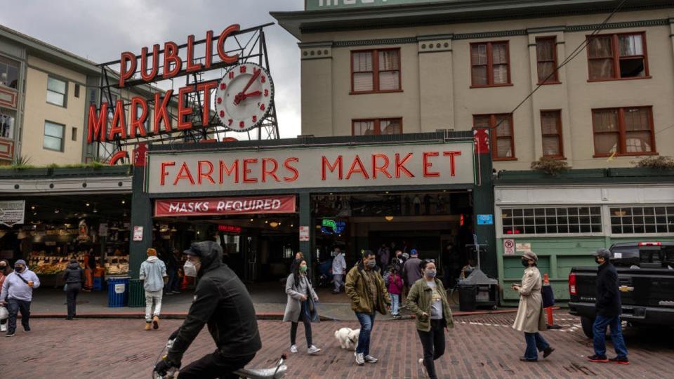 <div>People walk past the Pike Place Market, Seattle's top tourist destination on March 09, 2022, in Seattle, Wash.</div> <strong>(John Moore/Getty Images)</strong>