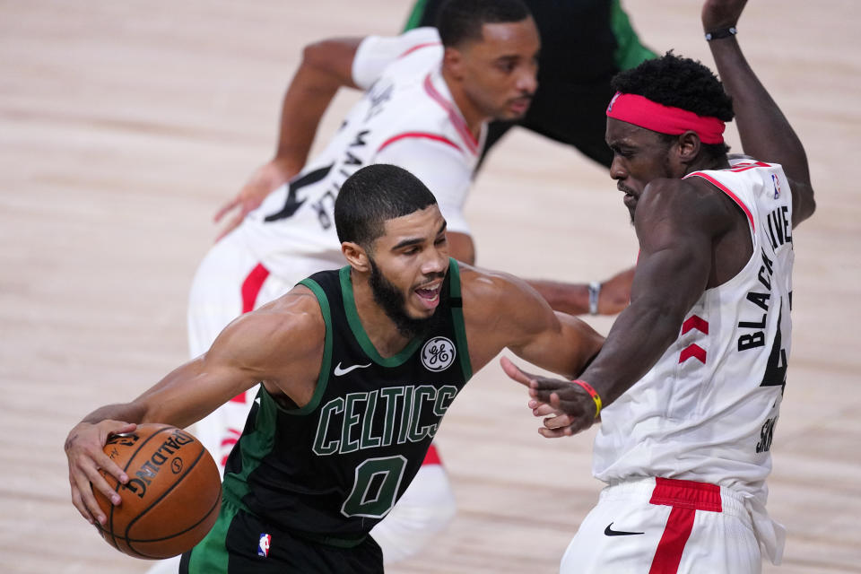 Boston Celtics' Jayson Tatum (0) drives against Toronto Raptors' Pascal Siakam during the second half of an NBA conference semifinal playoff basketball game Friday, Sept. 11, 2020, in Lake Buena Vista, Fla. (AP Photo/Mark J. Terrill)