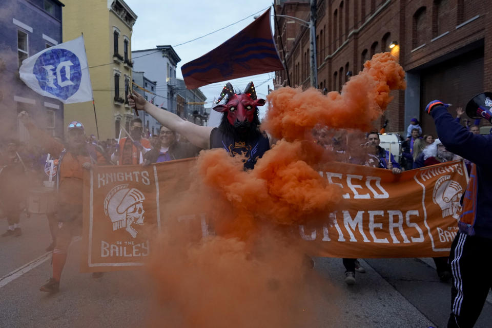 FC Cincinnati fans march to the stadium before the an MLS Eastern Conference Final soccer match between FC Cincinnati and Columbus Crew, Saturday, Dec. 2, 2023, in Cincinnati. (AP Photo/Carolyn Kaster)