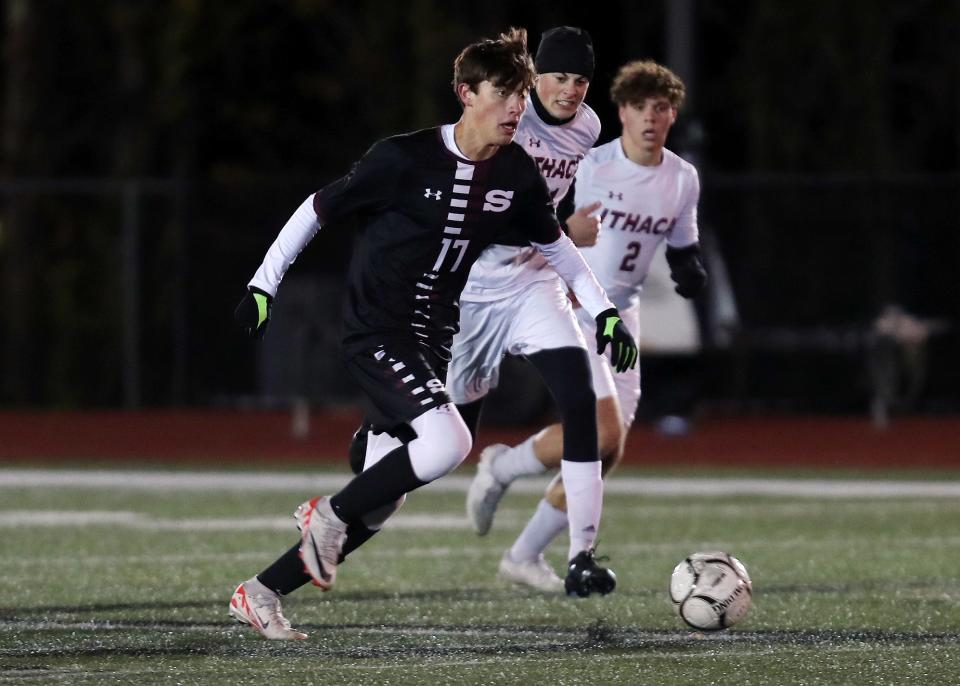 Scarsdale's Jose Alana Marino (17) moves the ball away from Ithaca's Eli Hajjar (21) during boys soccer regional playoff at Yorktown High School Nov. 1, 2023. Scarsdale won the game 4-2.