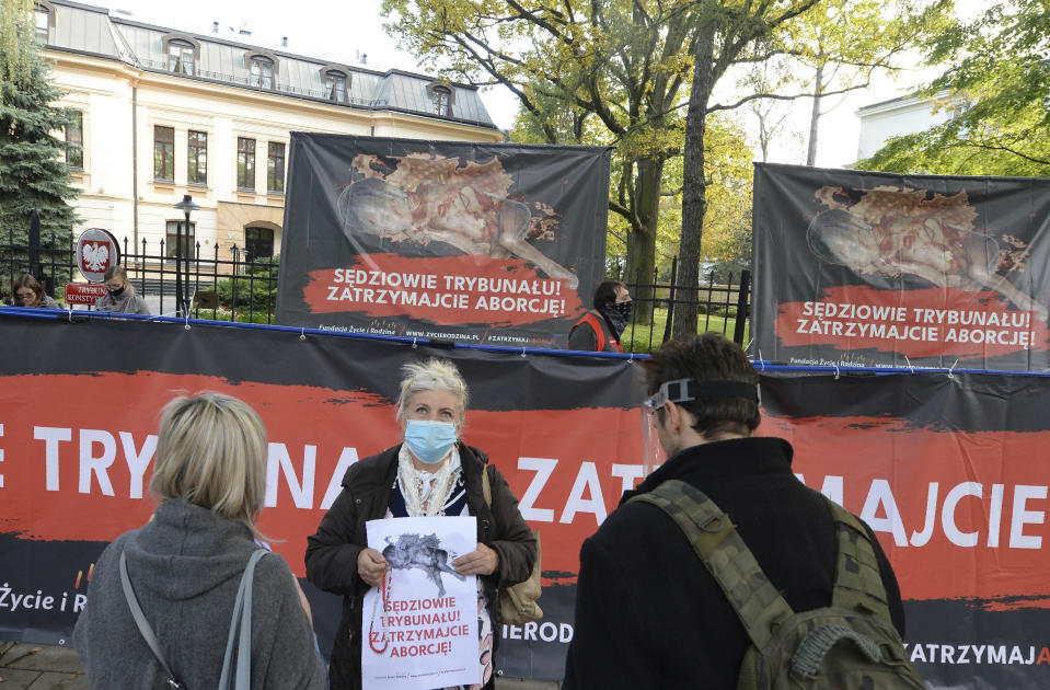 Anti-abortion activists attend a protest in front of Poland's constitutional court, in Warsaw, Poland, Thursday, Oct. 22, 2020. Poland’s top court has ruled that a law allowing abortion of fetuses with congenital defects is unconstitutional. The decision by the country’s Constitutional Court effectively bans terminating pregnancies in cases where birth defects are found and will further limit access to abortions in Poland. (AP Photo/Czarek Sokolowski)