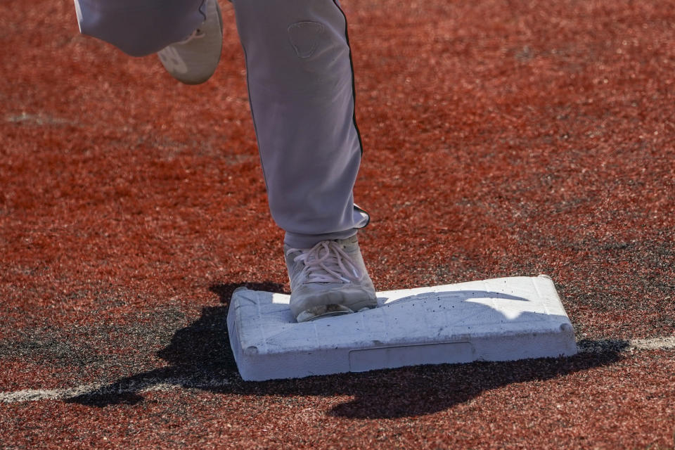 Larger bases are installed on the infield during a minor league baseball game between the Brooklyn Cyclones and Greensboro Grasshoppers, Wednesday, July 13, 2022, in the Coney Island neighborhood of the Brooklyn borough of New York. Major League Baseball is considering a pitch clock for next year along with shift limits, larger bases and restrictions on pickoff attempts. (AP Photo/John Minchillo)