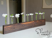 <body> <p>Turned on its narrow side, a humble bit of board becomes a refreshingly unique holder for backyard blooms. This clever crafter drilled holes for <a rel="nofollow noopener" href=" http://www.bobvila.com/articles/test-tube-crafts/#.VY1-OPlViko?bv=yahoo" target="_blank" data-ylk="slk:test tubes;elm:context_link;itc:0;sec:content-canvas" class="link ">test tubes</a>, then stained the wood a dark brown to create a modern centerpiece in about 30 minutes—and all for less than 20 bucks. </p> <p><strong>Related: <a rel="nofollow noopener" href=" http://www.bobvila.com/slideshow/10-totally-unexpected-things-to-remake-as-planters-48688/diy-planter-box#.VY1-RvlViko?bv=yahoo" target="_blank" data-ylk="slk:10 Totally Unexpected Things to Remake as Planters;elm:context_link;itc:0;sec:content-canvas" class="link ">10 Totally Unexpected Things to Remake as Planters</a> </strong> </p> </body>