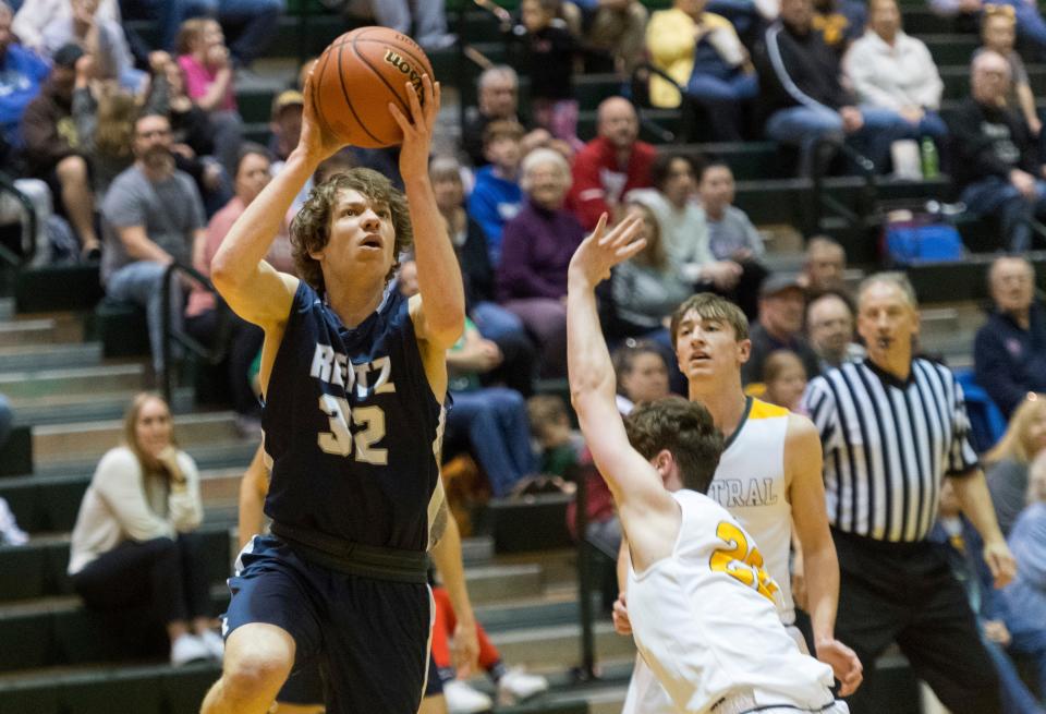 Reitz’s Isaac Higgs (32) puts up a shot as the Reitz Panthers play the Central Bears during the first round of the IHSAA Class 4A boys basketball sectional held at North High School in Evansville, Ind., Tuesday, March 1, 2022.