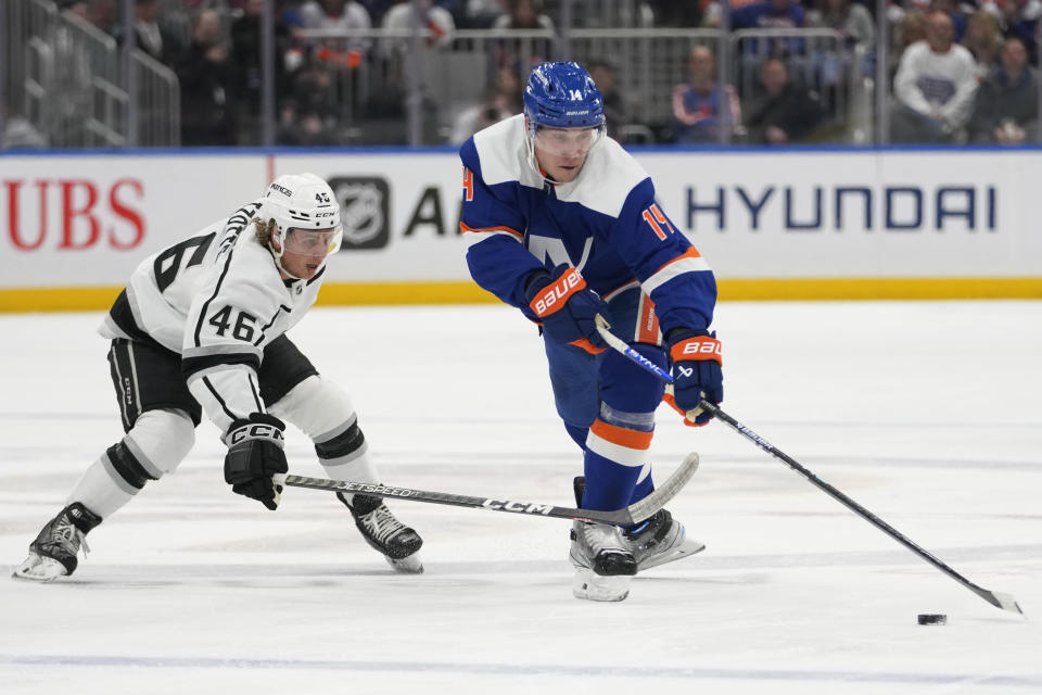 New York Islanders center Bo Horvat (14) reaches for the puck as Los Angeles Kings center Blake Lizotte (46) defends during the second period of an NHL hockey game Friday, Feb. 24, 2023, in Elmont, N.Y. (AP Photo/Mary Altaffer)