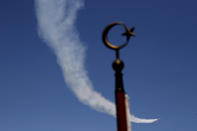 Turkish acrobatic aircraft jets fly, during a military parade celebration marking the 45th anniversary of the 1974 Turkish invasion in the Turkish occupied area of the divided capital Nicosia, Cyprus, Saturday, July 20, 2019. Cyprus was split into Greek Cypriot south and Turkish Cypriot north in 1974 when Turkey invaded in response to a coup by supporters of a union with Greece. (AP Photo/Petros Karadjias)