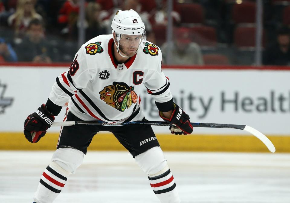 FILE - In this March 26, 2019, file photo, Chicago Blackhawks center Jonathan Toews pauses during the first period of an NHL hockey game against the Arizona Coyotes in Glendale, Ariz. Under the terms of the collective bargaining agreement, NHL owners and players divide hockey-related revenue 50/50, and if player salaries exceed that split a certain percentage is withheld in escrow to make it even. The Blackhawks captain and fellow players have lost upwards of 10% of their pay to escrow over the past seven seasons, which is why 25 of 31 NHL Players’ Association representatives surveyed by The Associated Press and Canadian Press named escrow as the biggest bargaining issue with September deadlines looming to terminate the current CBA effective the fall of 2020. (AP Photo/Ross D. Franklin, File)