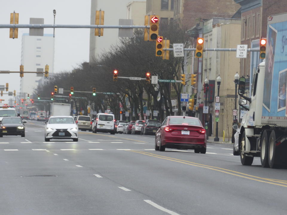 Vehicles stop at traffic lights along Atlantic Avenue in Atlantic City, N.J. on Jan. 26, 2024. Several casinos and a hospital wanted a judge to block the city's plan to reduce the width of the street, the main artery through Atlantic City's downtown, from four lanes to two. But on Jan. 24, 2024 the judge refused to do so. (AP Photo/Wayne Parry)