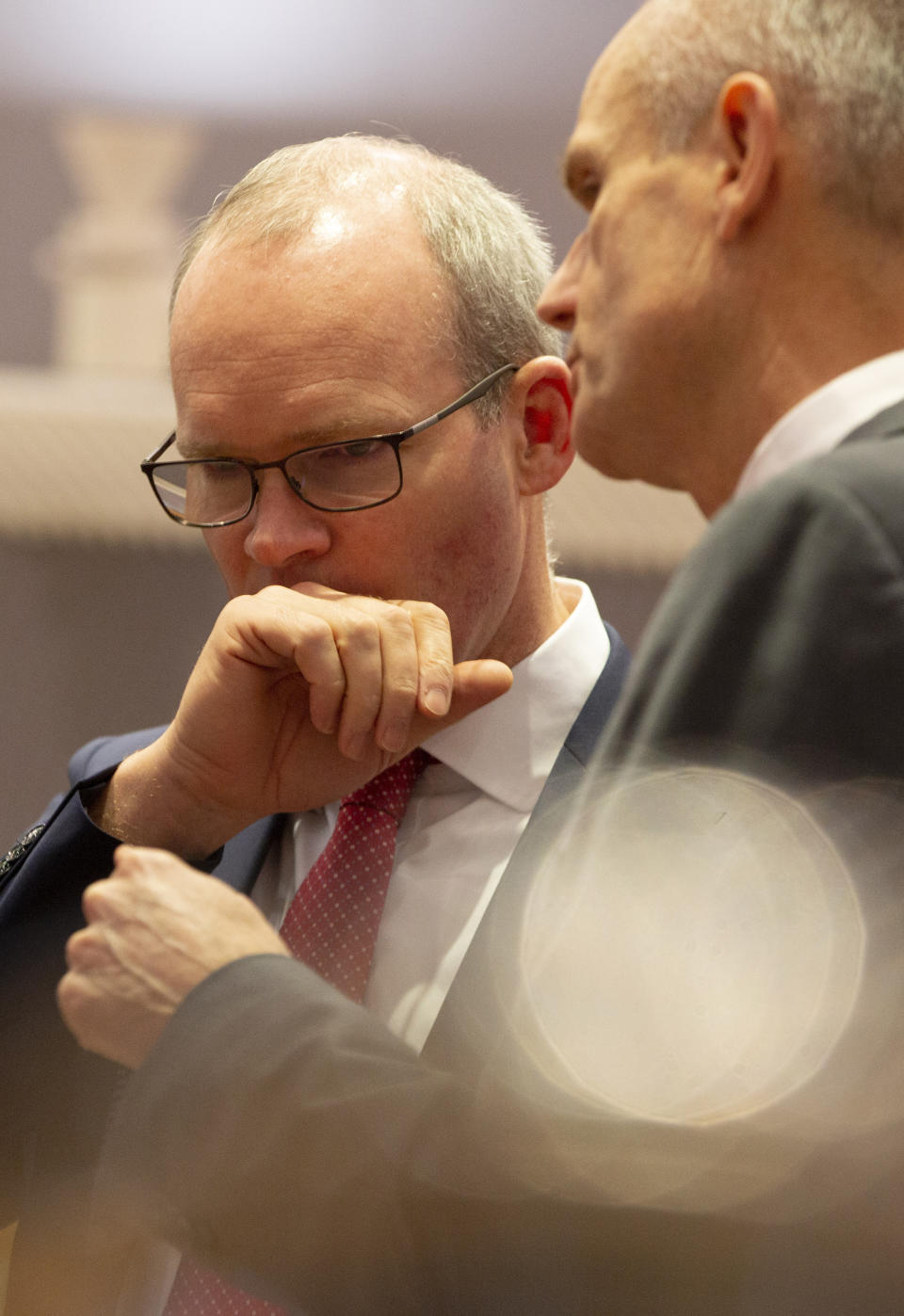 Irish Foreign Minister Simon Coveney, left, speaks with Dutch Foreign Minister Stef Blok during a meeting of EU foreign ministers at the Europa building in Brussels, Monday, Dec. 9, 2019. European Union foreign ministers are debating how to respond to a controversial deal between Turkey and Libya that could give Ankara access to a contested economic zone across the Mediterranean Sea. (AP Photo/Virginia Mayo)