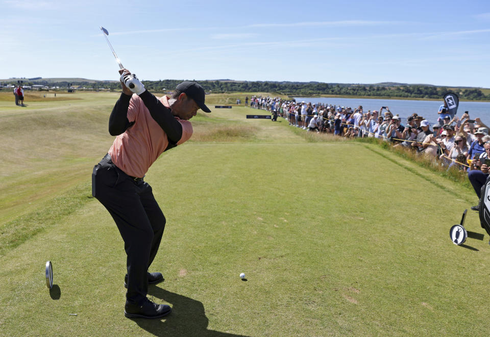 U.S golfers Justin Thomas, right, and Tiger Woods tee off on the 12th hole during a practice round at the British Open golf championship on the Old Course at St. Andrews, Scotland, Sunday July 10, 2022. The Open Championship returns to the home of golf on July 14-17, 2022, to celebrate the 150th edition of the sport's oldest championship, which dates to 1860 and was first played at St. Andrews in 1873. (AP Photo/Peter Morrison)