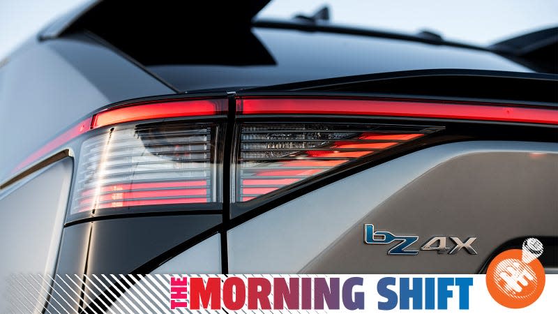 A Toyota press photo of the badge of a BZ4X EV with the Jalopnik "Morning Shift" banner overlaid