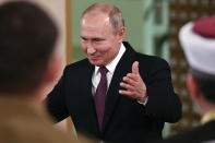 Russian President Vladimir Putin gestures while speaking during a meeting with local residents in Simferopol, Crimea, Monday, March 18, 2019. Putin visited Crimea to mark the fifth anniversary of Russia's annexation of Crimea from Ukraine by visiting the Black Sea peninsula. (Yuri Kadobnov/Pool Photo via AP)