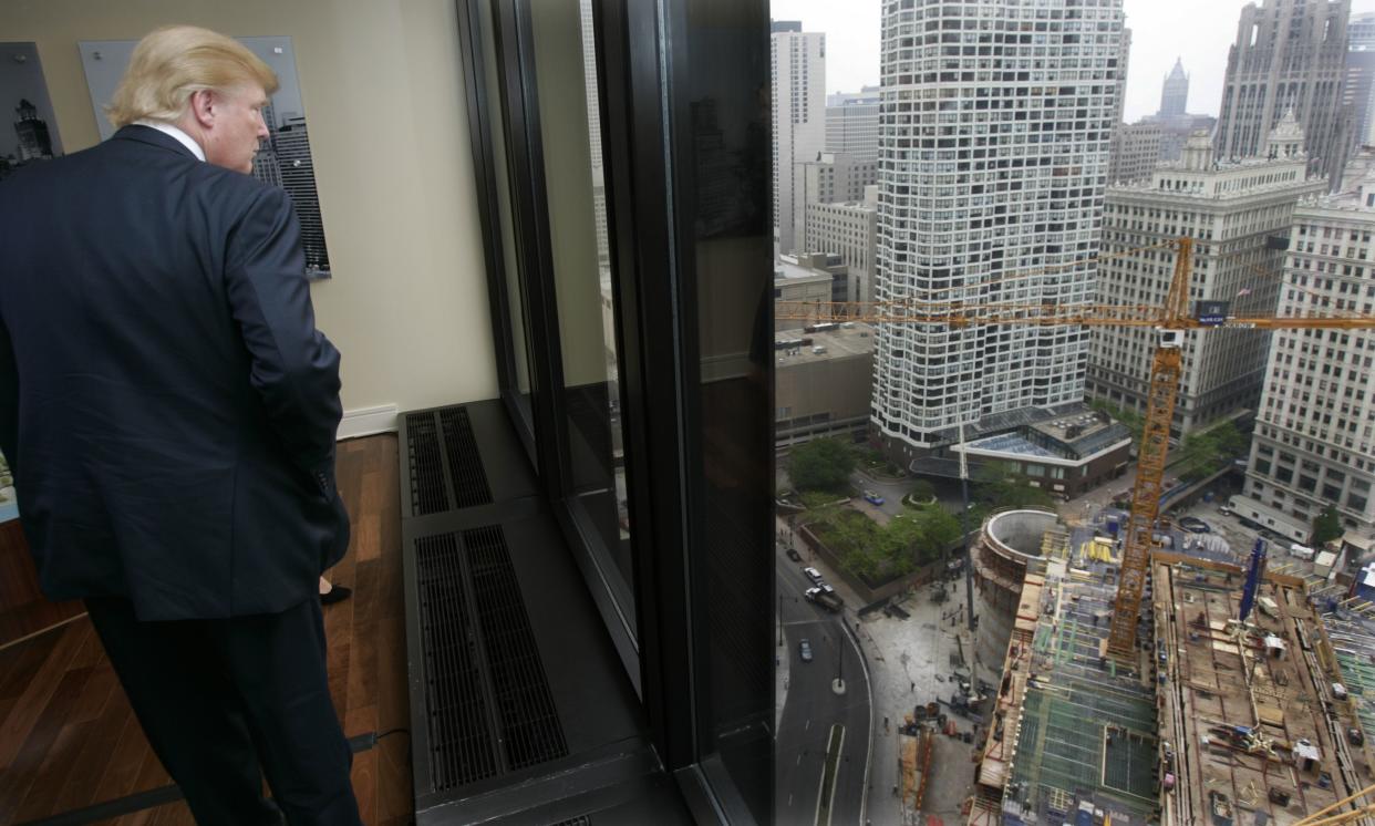 Donald Trump looks out at the construction site of his 92-story tower along the Chicago river during a visit to his Chicago offices Wednesday, April 10, 2006. 