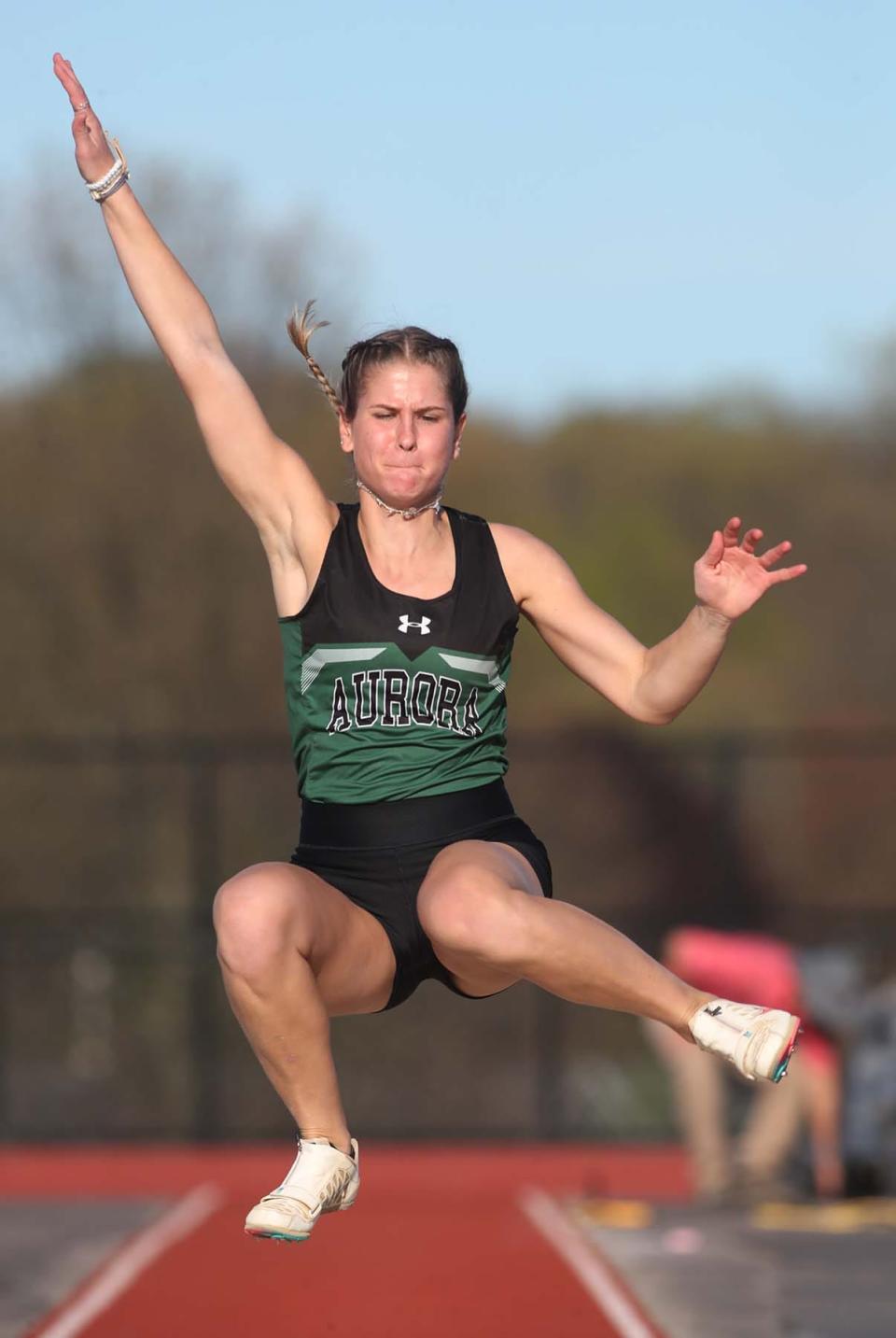 Lauren Tincher of Aurora jumps over 18 feet to place first in long jump at the Suburban League American Conference Track Meet at Tallmadge High School in Tallmadge on Monday.