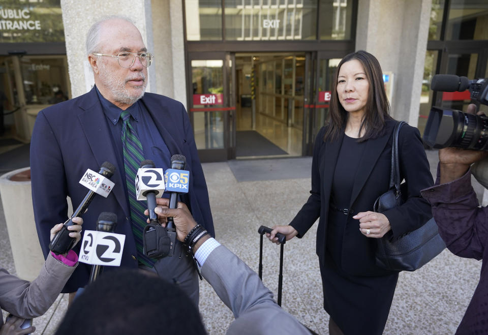 Geoffrey Carr, left, and May Mar attorney's for Tiffany Li, talks with reporters outside the courthouse after opening statements were delayed in Li's trial, Thursday, Sept. 12, 2019, in Redwood City, Calif. Li, a Chinese real estate scion, posted a $35 million bail after being charged with orchestrating the 2016 murder of her children's father. (AP Photo/Tony Avelar)