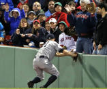 Fans watch as New York Yankees right fielder Brett Gardner cannot make the catch on a ground-rule double by Boston Red Sox's Mike Napoli during the third inning of a baseball game at Fenway Park in Boston, Wednesday, April 23, 2014. Dustin Pedroia scored on the hit. (AP Photo/Elise Amendola)