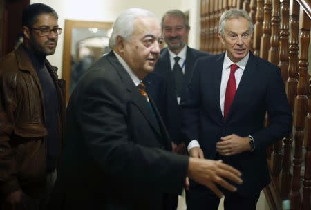 Quartet Representative to the Middle East and former British prime minister Tony Blair (R) stands next to Palestinian Minister of Work Mamoun Abu Shahla during Blair's visit to Gaza City February 15, 2015. REUTERS/Suhaib Salem