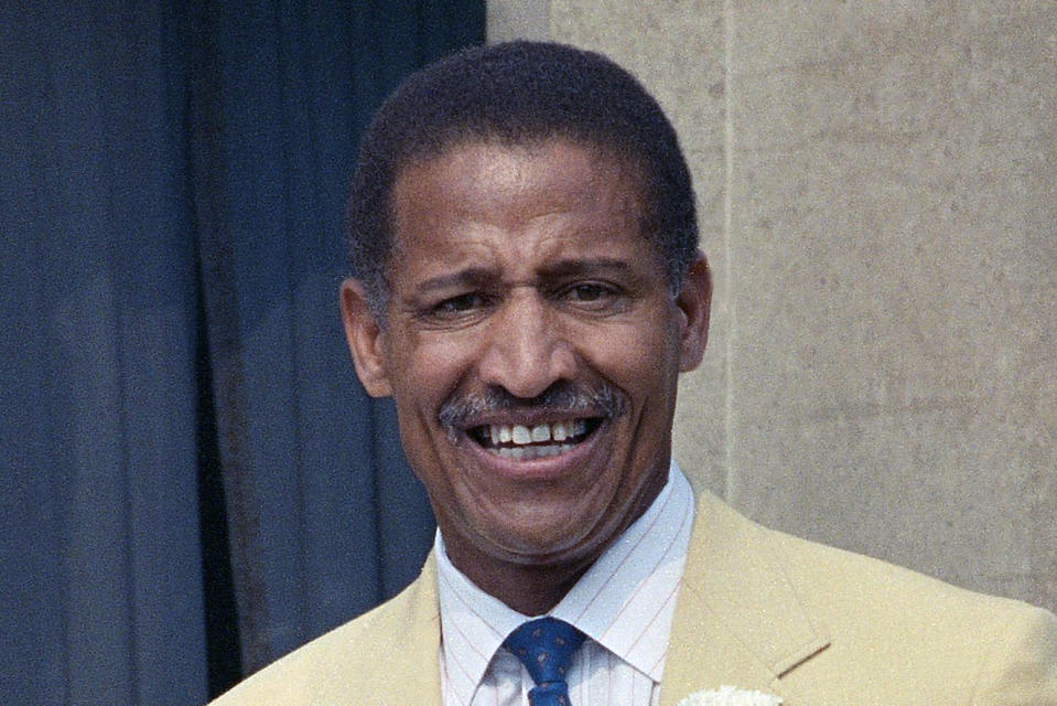 FILE - This 1990 file photo shows Former football player Junious "Buck" Buchanan during induction ceremonies at the Pro Football Hall of Fame in Caston, Ohio. Two years before Clark Hunt was born, the Kansas City Chiefs made history by taking Grambling State defensive tackle Buck Buchanan in the American Football League draft, making him the first black player from any college — much less a historically black one — to be the first player selected first overall. It was a testament to the progressive nature of Hunt's father, Chiefs founder Lamar Hunt. (AP Photo/File)