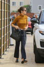 <p>Selena Gomez paired her $325 pinstripe denim and metal belt from Miaou with a crop top and a black handbag during an outing in Malibu in March 2017. (Photo: AKM-GSI) </p>