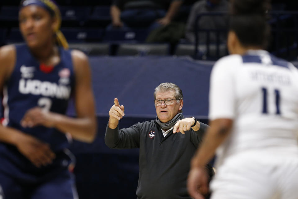 Connecticut head coach Geno Auriemma, center, directs his team against Xavier during the second half of an NCAA college basketball game Saturday, Feb. 20, 2021, in Cincinnati. UConn won 83-32. (AP Photo/Gary Landers)