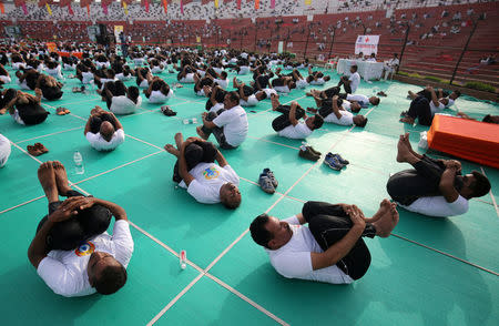 Indian paramilitary soldiers perform yoga at a stadium during International Yoga Day in Ahmedabad, India, June 21, 2018. REUTERS/Amit Dave