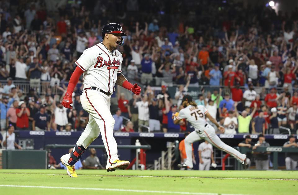 Atlanta Braves second baseman Orlando Arcia reacts to hitting a walk off single off San Francisco Giants pitcher Camilo Doval, right, for a 2-1 victory during the ninth inning of a baseball game on Monday, June 20, 2022, in Atlanta. (Curtis Compton/Atlanta Journal-Constitution via AP)