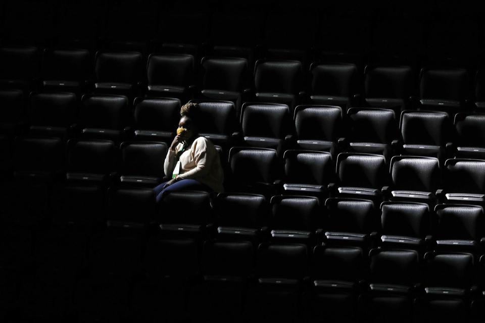 A woman sits in the stands during team introductions before on an NBA basketball game between the Boston Celtics and the Orlando Magic, Sunday, March 21, 2021, in Boston. Some employees of the Celtics and TD Garden were present as a dry run before a limited number of fans will be allowed at games beginning on Monday. (AP Photo/Michael Dwyer)