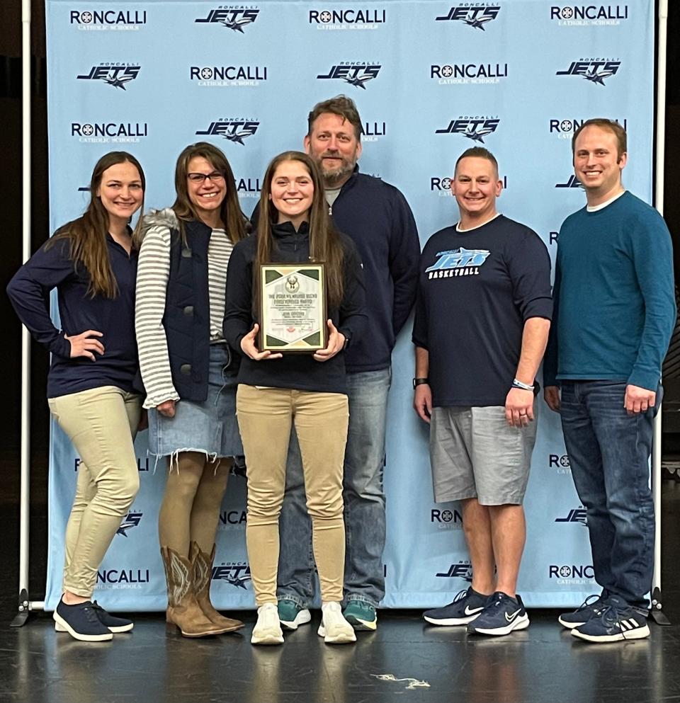 Milwaukee Bucks Perseverance Award recipient senior Jena Garceau, center, stands with her parents, Heather and Tim Garceau, and girls basketball coach Amanda Kudick, far left, Roncalli Catholic Schools Athletic Director Nathan Kaderabek and softball coach Adam Wachowski, far right.