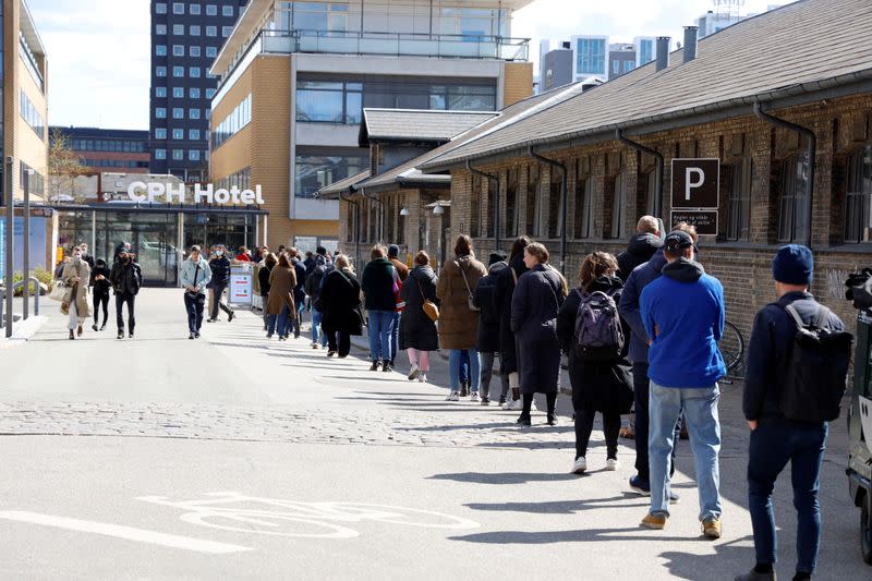 FILE PHOTO: People wait in line at a free COVID-19 antigen test centre in Copenhagen