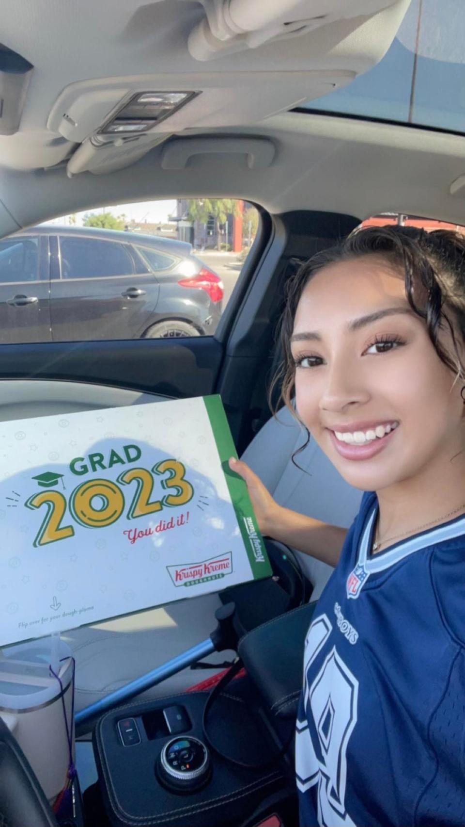 Eastlake High School senior Alexia Dozal got up early to get her free doughnuts from Krispy Kreme. The box says Dough-ploma on the bottom.