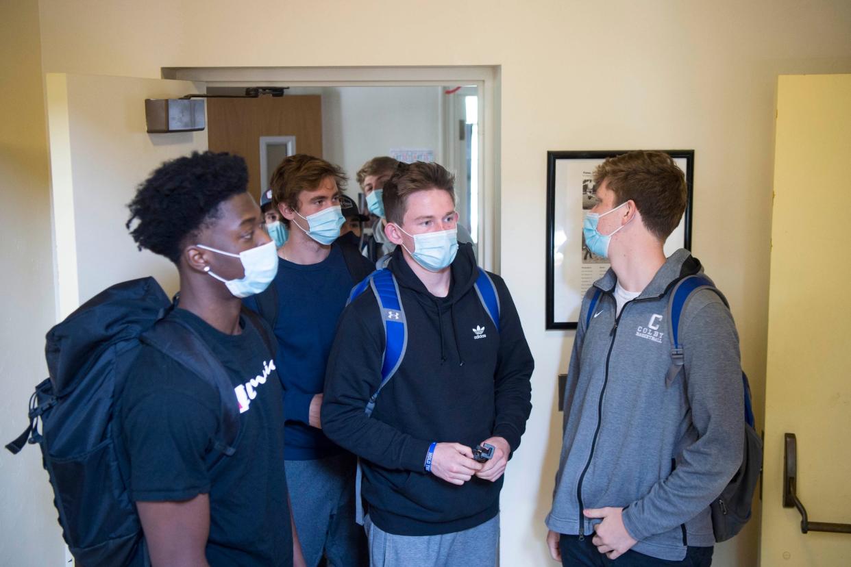 Colby College students, from left, Jonah Obi, Kevin O'Boy, Alec McGovern and Will King exit their classroom to head outside for a video exercise during a class called Choreography for the Camera: The Art of Athletics.