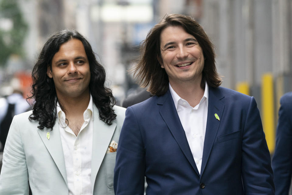 Vladimir Tenev, CEO and Co-Founder of Robinhood, right, walks in New York's Times Square with fellow Co-Founder Baiju Bhatt following their company's IPO, Thursday, July 29, 2021. Robinhood is selling its own stock on Wall Street, the very place the online brokerage has rattled with its stated goal of democratizing finance. Through its app, Robinhood has introduced millions to investing and reshaped the brokerage industry, all while racking up a long list of controversies in less than eight years. (AP Photo/Mark Lennihan)