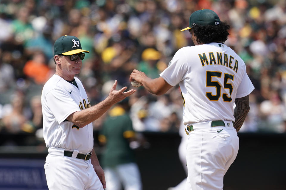 Oakland Athletics starting pitcher Sean Manaea (55) hands the ball to manager Bob Melvin as he is taken out for a relief pitcher during the fifth inning of the team's baseball game against the San Francisco Giants in Oakland, Calif., Saturday, Aug. 21, 2021. (AP Photo/Jeff Chiu)