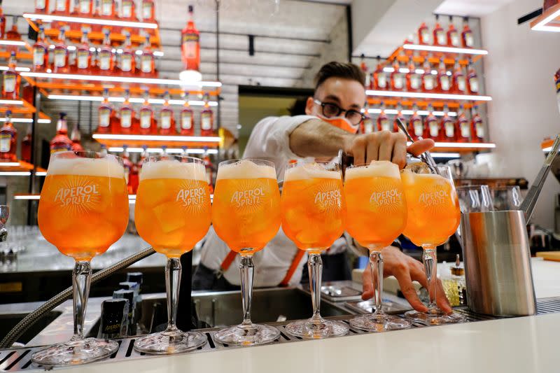 FILE PHOTO: A bartender pours a drink at a Campari inauguration of a new brand house for Aperol, its best-selling beverage, in Venice, Italy