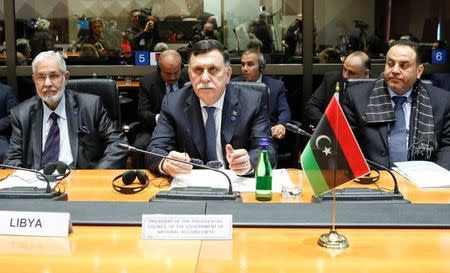 Faiez Mustafa Serraj, President of the Presidency Council of the Government of National Accord of Libya (C) sits next to Libya's Foreign Minister Mohamed Taha Siala (L) and Interior Minister Al-Aref Al-Khoja during a meeting in Rome, Italy March 20, 2017. REUTERS/Remo Casilli