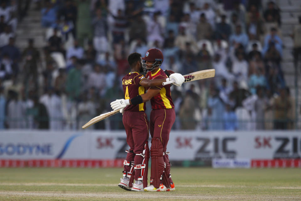 West Indies Shai Hope, left, celebrates with teammate Brandon King after scoring century during the first one day international cricket match between Pakistan and West Indies at the Multan Cricket Stadium, in Multan, Pakistan, Wednesday, June 8, 2022. (AP Photo/Anjum Naveed)