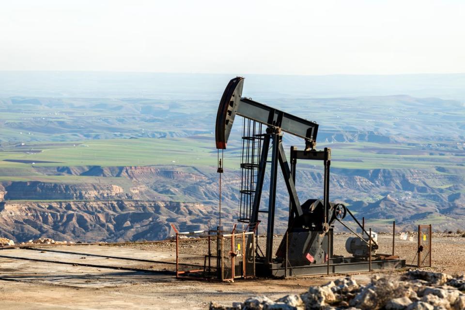 A pumpjack in an open landscape.