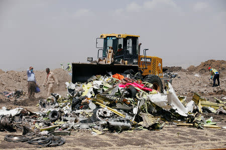 A bulldozer scopes the debris of the Ethiopian Airlines Flight ET 302 plane crash before a commemoration ceremony at the scene of the crash, near the town of Bishoftu, southeast of Addis Ababa, Ethiopia. March 13, 2019. REUTERS/Baz Ratner