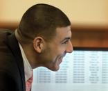 Former National Football League player Aaron Hernandez looks on as a courtroom monitor displays cell phone records during his murder trial in Bristol County Superior Court in Fall River, Massachusetts February 27, 2015. Hernandez is accused of murdering Odin Lloyd, a semi-professional football player who was dating his fiancee's sister. REUTERS/Ted Fitzgerald/Pool (UNITED STATES - Tags: CRIME LAW SPORT FOOTBALL)