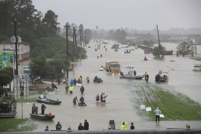 Residents of Houston evacuate their homes after the area was flooded from Hurricane Harvey, Aug. 28, 2017