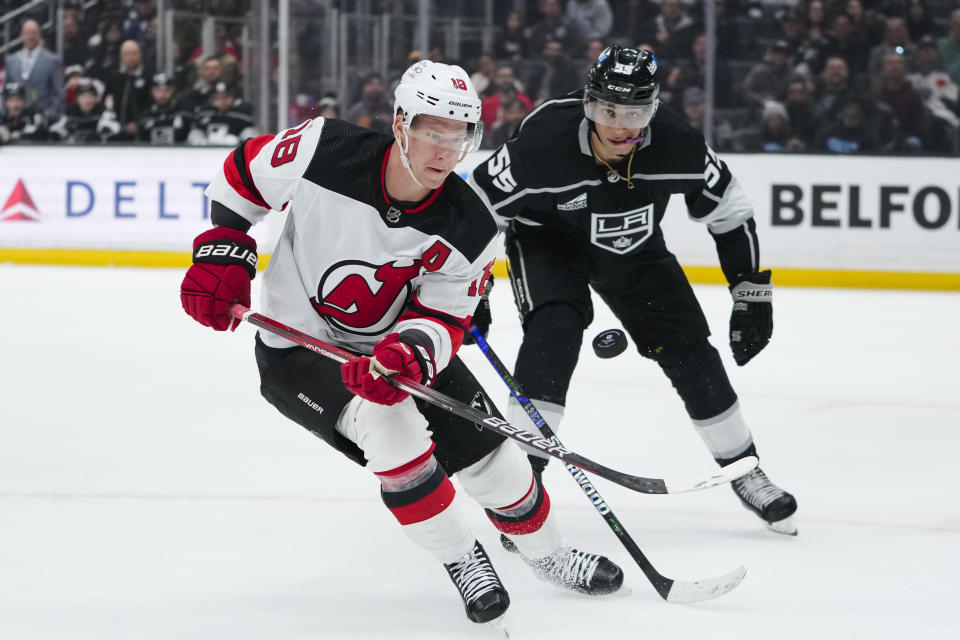 New Jersey Devils left wing Ondrej Palat, left, and Los Angeles Kings right wing Quinton Byfield vie for the puck during the first period of an NHL hockey game, Sunday, March 3, 2024, in Los Angeles. (AP Photo/Ryan Sun)