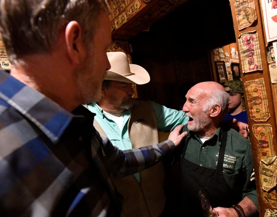 Ali Esfandiary is greeted by customers who have come to enjoy the Fort Griffin General Merchandise and Beehive Saloon in Albany one last time.