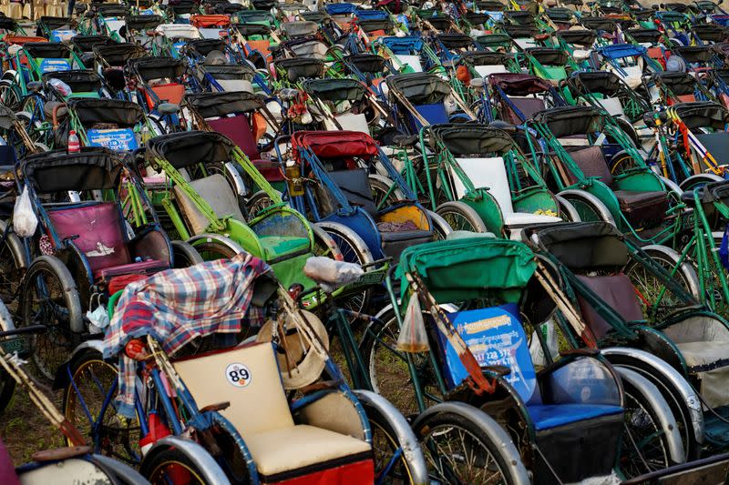 Tricycles lined up to provide seating for an outdoor movie screening held by a held by a NGO in Phnom Penh