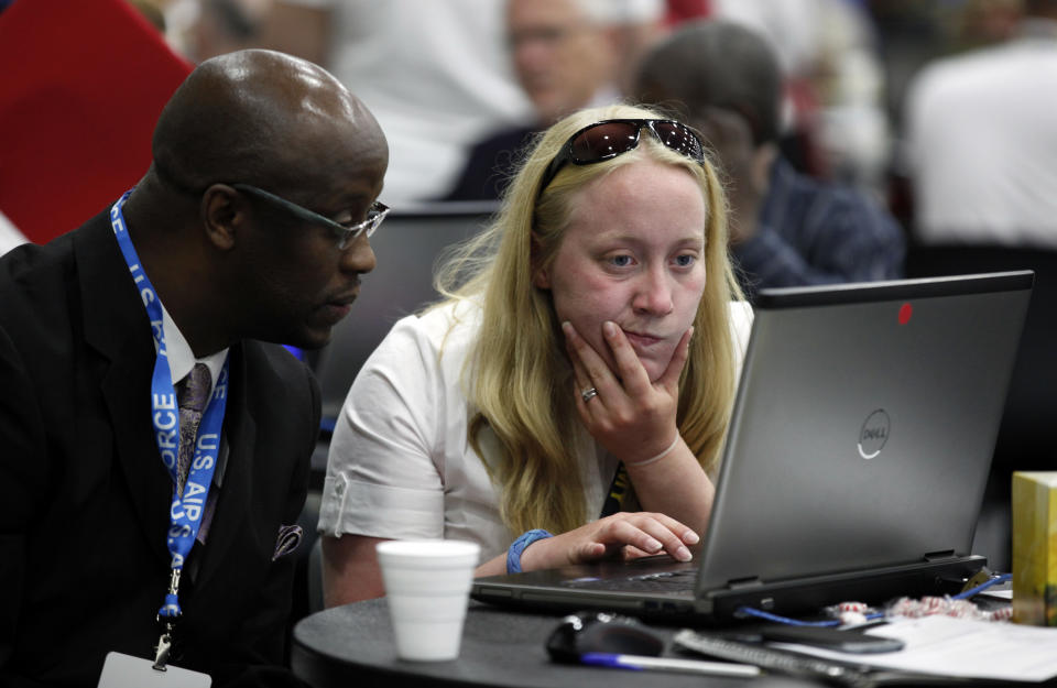 Tressa Miller, right, helps military veteran Roger Porter, of Detroit, with resume career counseling in Detroit, Tuesday, June 26, 2012. Thousands of veterans are in Detroit this week for job fair, open house, small business conference. (AP Photo/Paul Sancya)