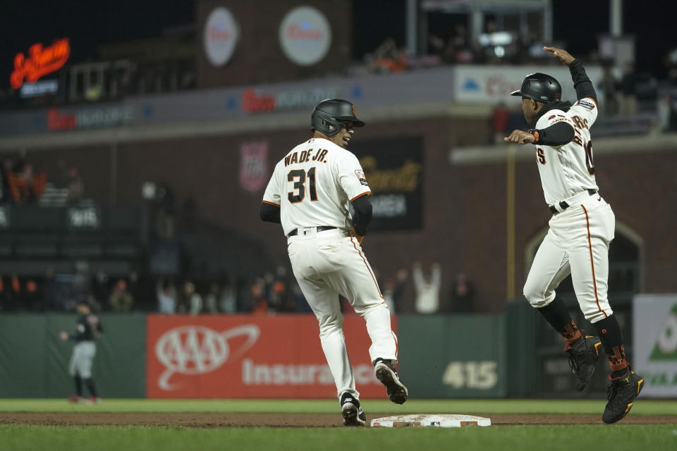 San Francisco Giants' LaMonte Wade Jr., left, celebrates with first base coach Antoan Richardson, right, after hitting the game-winning RBI single against the Cleveland Guardians during the 10th inning of a baseball game Monday, Sept. 11, 2023, in San Francisco. (AP Photo/Godofredo A. Vásquez)