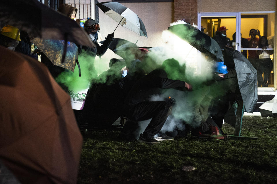 A demonstrator is shot with a less-than-lethal munition from police outside the Brooklyn Center Police Department while protesting the shooting death of Daunte Wright, Tuesday, April 13, 2021, in Brooklyn Center, Minn. (AP Photo/John Minchillo)