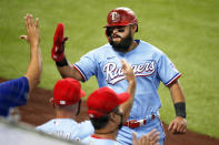 Texas Rangers' Rougned Odor is greeted at the dugout after scoring on an RBI-single by Elvis Andrus in the fourth inning of a baseball game against the Los Angeles Angels in Arlington, Texas, Sunday, Aug. 9, 2020. (AP Photo/Ray Carlin)