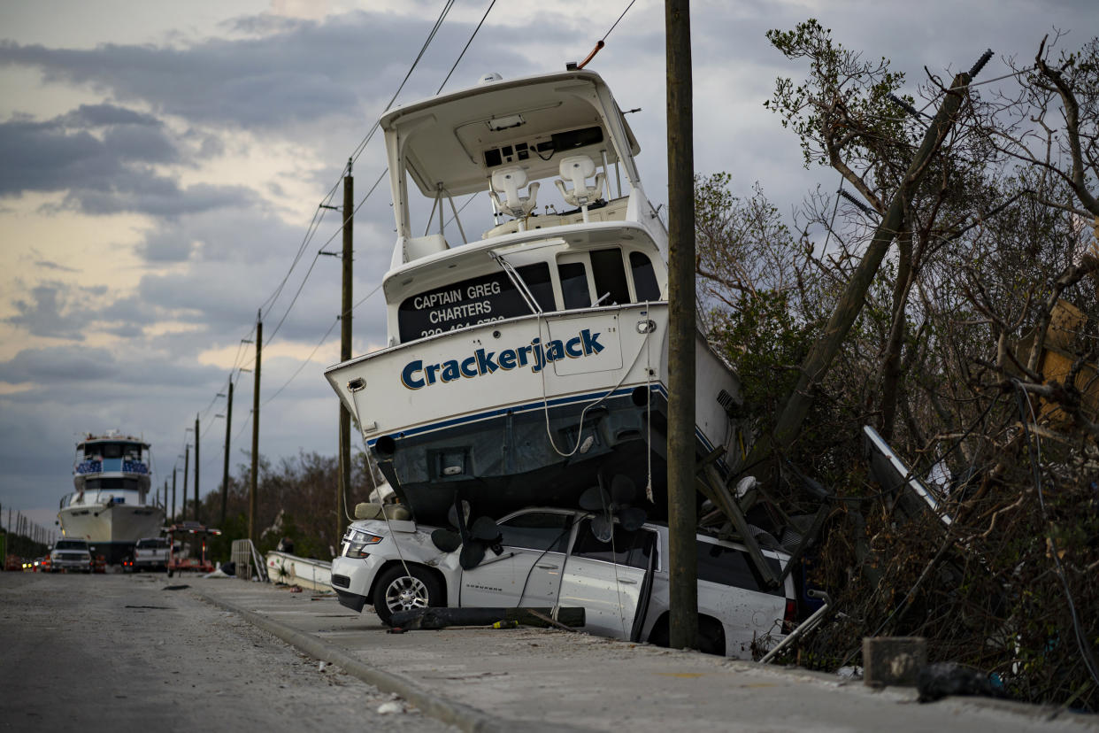 A charter boat sits on top of a SUV on Oct. 31, a month after Hurricane Ian ravaged Fort Myers Beach, Fla. (Thomas Simonetti for NBC News)