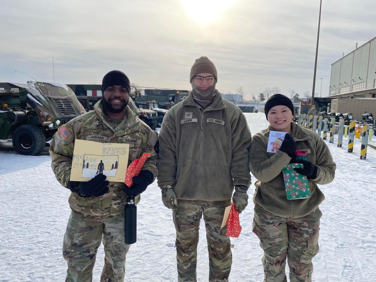 U.S. soldiers on assignment in South Korea hold up messages from Barberton Intermediate School students. More than 200 letters were sent by students, arriving the week of Dec. 11.
